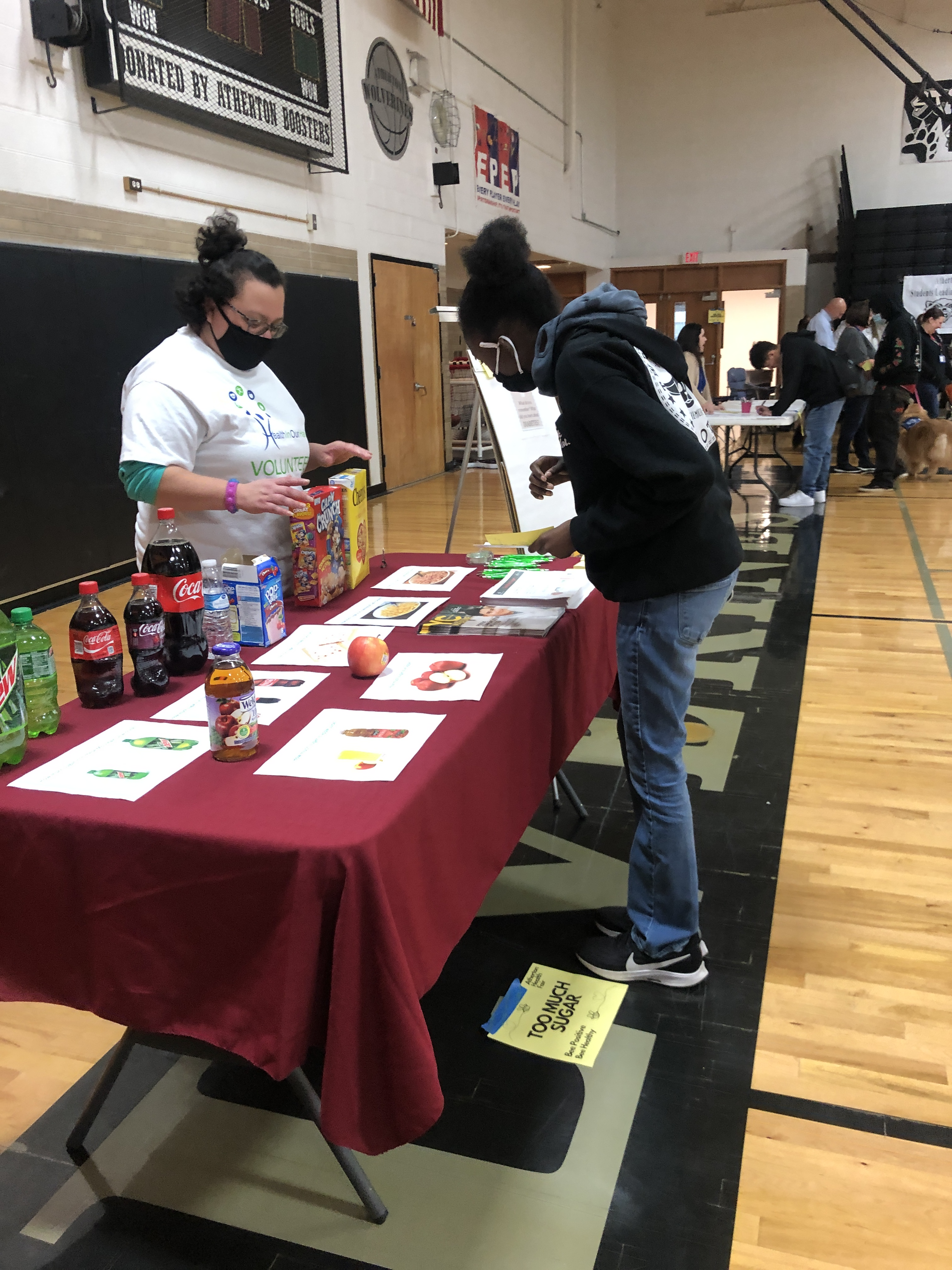 Maria Salinas Project Coordinator with Health in Our Hands engaging with a student 